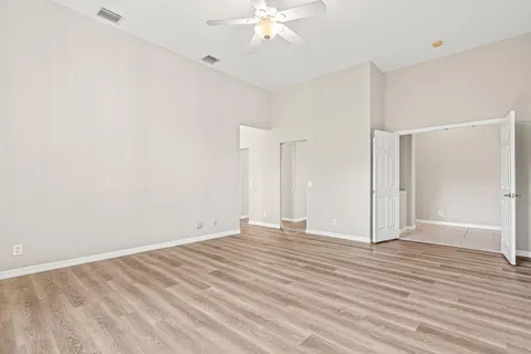 a view of an empty room with wooden floor