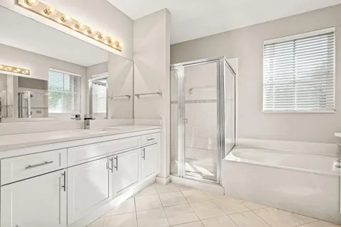 a bathroom with a sink toilet double vanity and shower