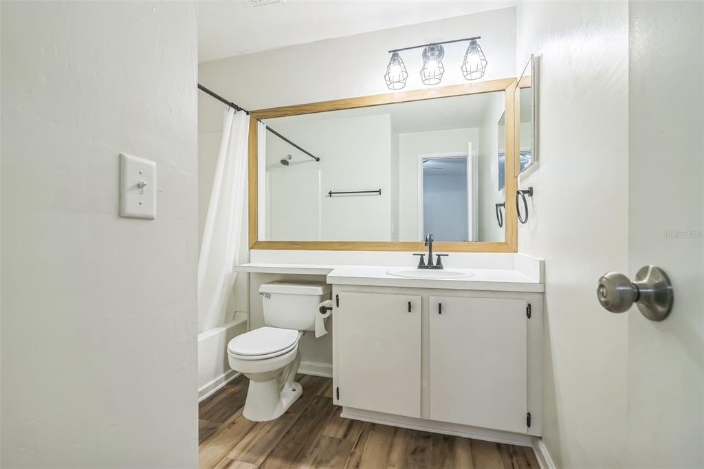 3800 Southwest 20th Avenue, Unit 112 Gainesville, FL 32607 - Photo 12 of 18 a bathroom with a toilet a sink and mirror