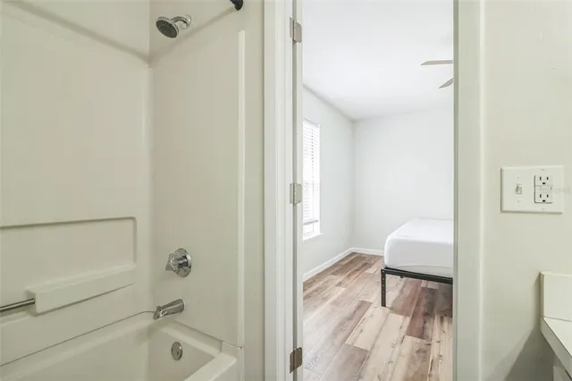 a bathroom with a tub sink and a mirror