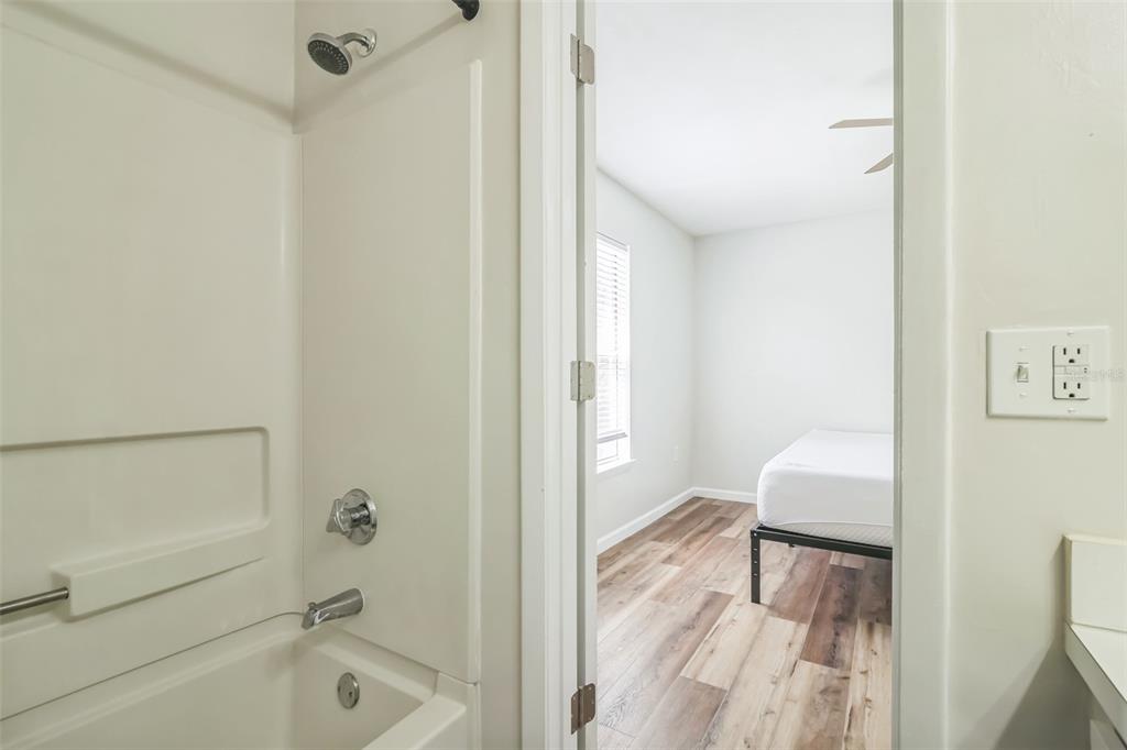 3800 Southwest 20th Avenue, Unit 112 Gainesville, FL 32607 - Photo 14 of 18 a bathroom with a tub sink and a mirror