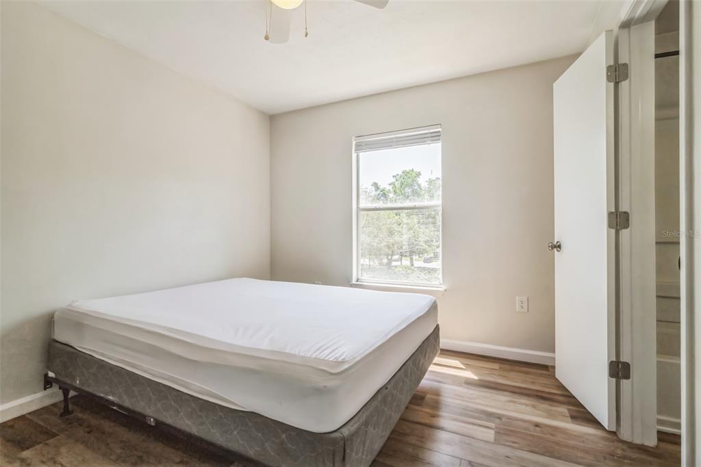 3800 Southwest 20th Avenue, Unit 112 Gainesville, FL 32607 - Photo 16 of 18 a bedroom with a bed and a window