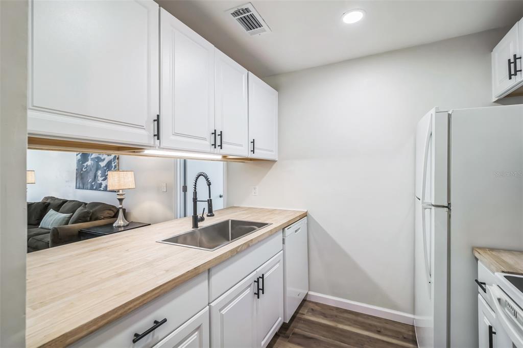 3800 Southwest 20th Avenue, Unit 112 Gainesville, FL 32607 - Photo 4 of 18 a kitchen with stainless steel appliances granite countertop a sink and a refrigerator