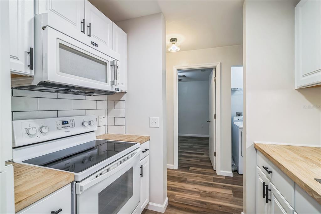 3800 Southwest 20th Avenue, Unit 112 Gainesville, FL 32607 - Photo 5 of 18 a kitchen with a stove microwave and sink