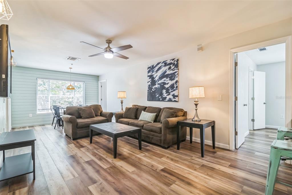 3800 Southwest 20th Avenue, Unit 112 Gainesville, FL 32607 - Photo 7 of 18 a living room with furniture and a wooden floor
