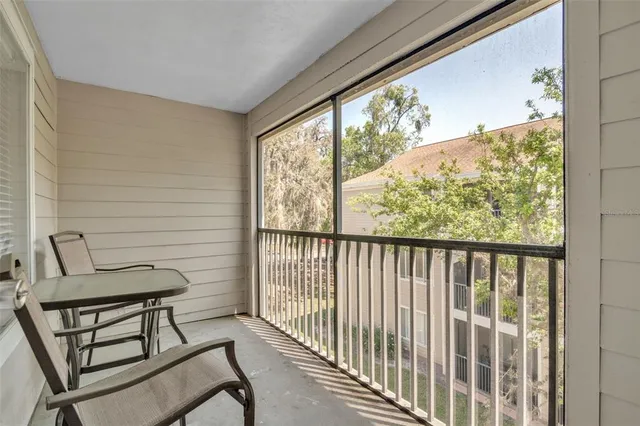 a view of a chairs and table in the balcony