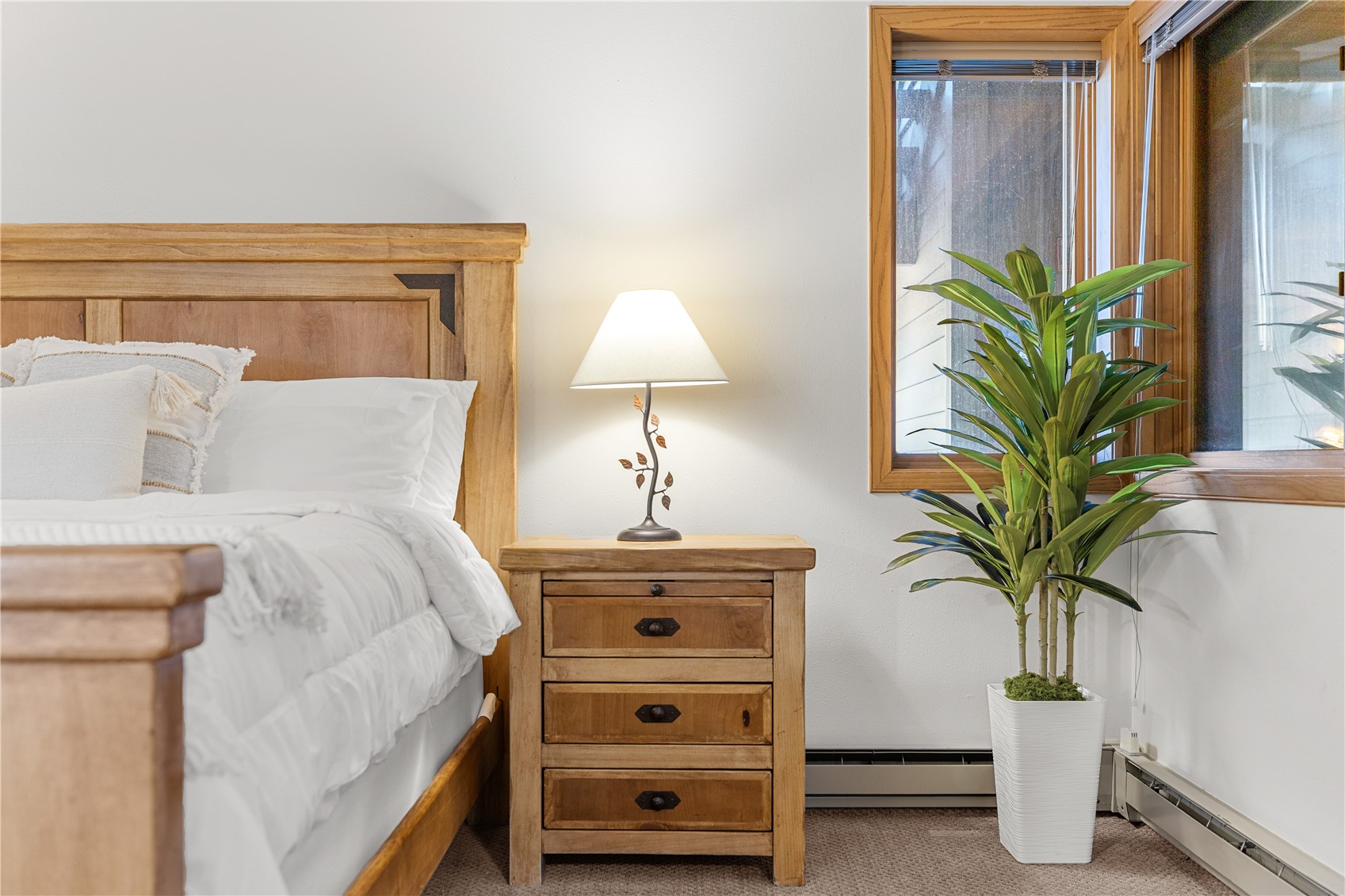 22804 Highway 6, Unit 102 Keystone, CO 80435 - Photo 14 of 34 a bedroom with a bed and a potted plant