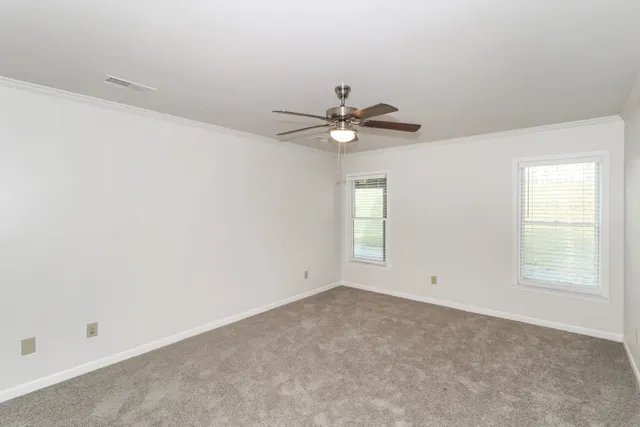 a kitchen with stainless steel appliances granite countertop a refrigerator a sink and white cabinets