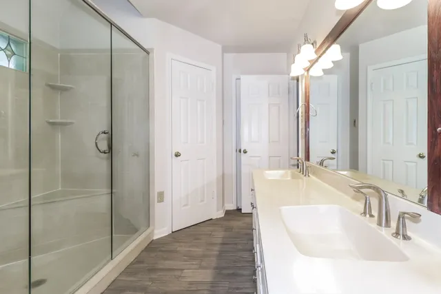 an empty room with windows and ceiling fan