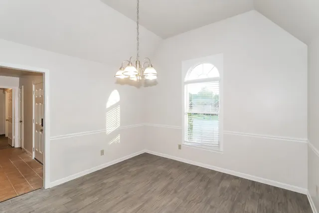 a view of an empty room with a fireplace and a window