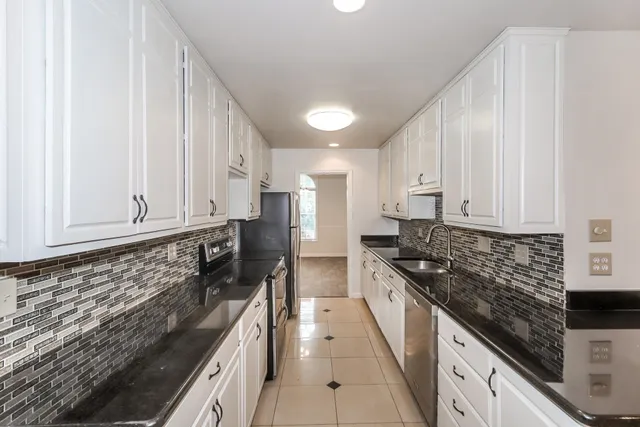 an empty room with ceiling fan and window