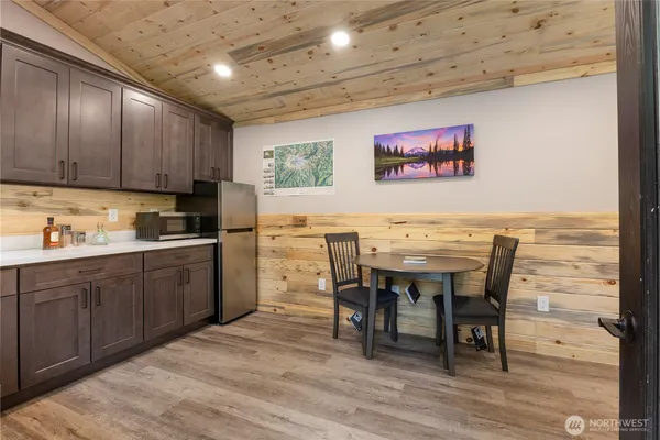 a kitchen with a table chairs sink and cabinets