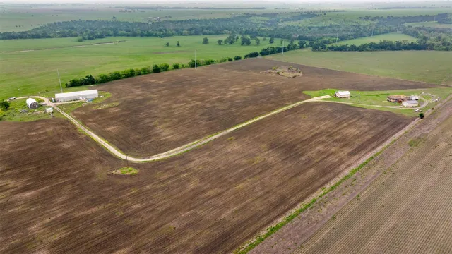 an aerial view of a house with a yard and lake view