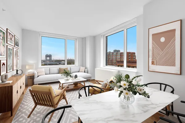 a living room with furniture and floor to ceiling windows