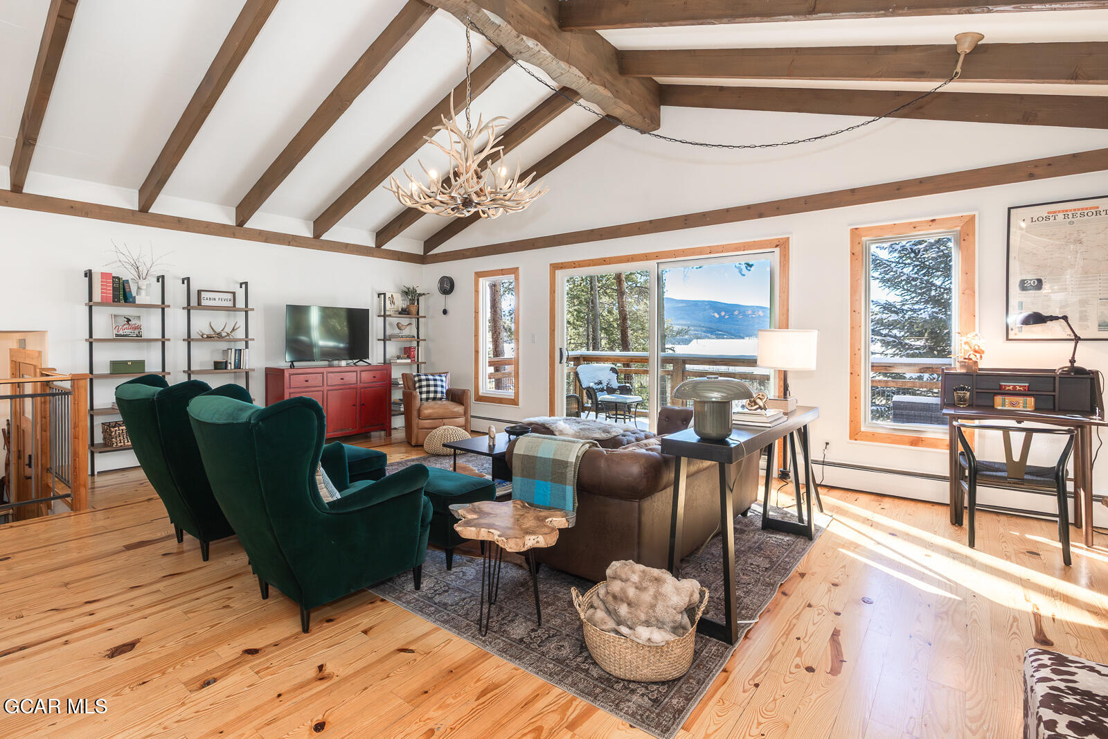 382 County Road 837 Fraser, CO 80442 - Photo 12 of 46 a living room with furniture and a floor to ceiling window