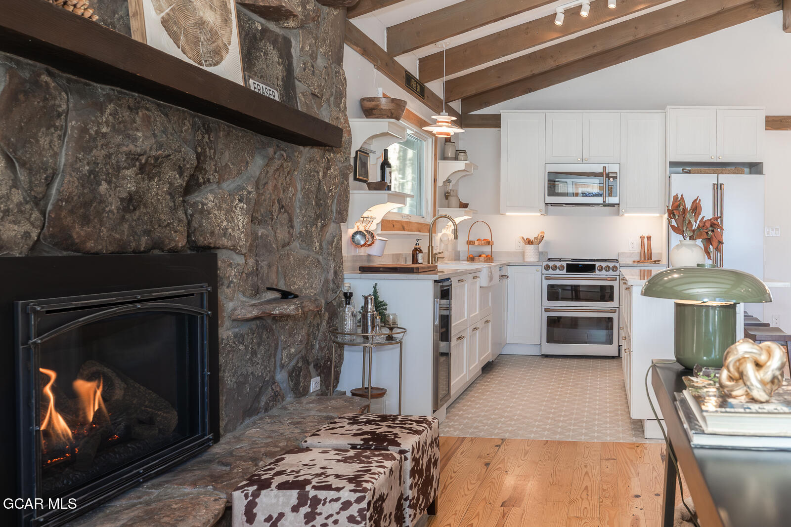 382 County Road 837 Fraser, CO 80442 - Photo 14 of 46 a kitchen with stainless steel appliances granite countertop a stove a washer and dryer