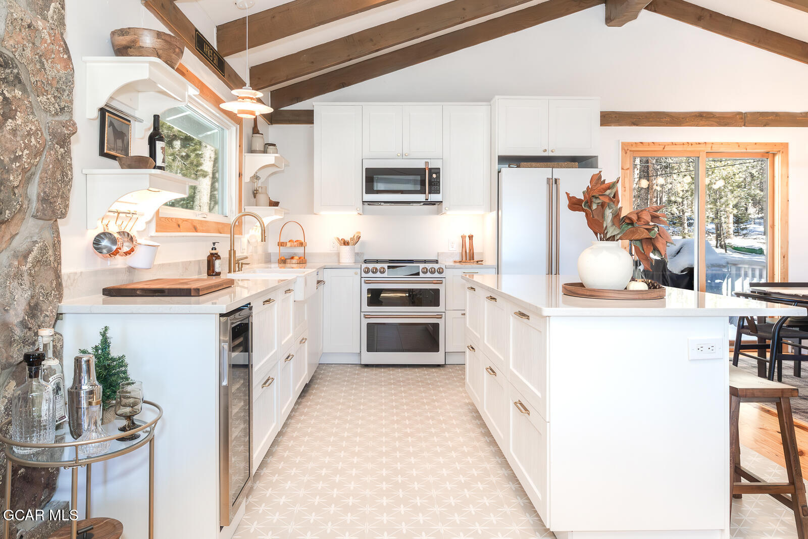 382 County Road 837 Fraser, CO 80442 - Photo 15 of 46 a kitchen with stainless steel appliances a white stove top oven a sink and a refrigerator