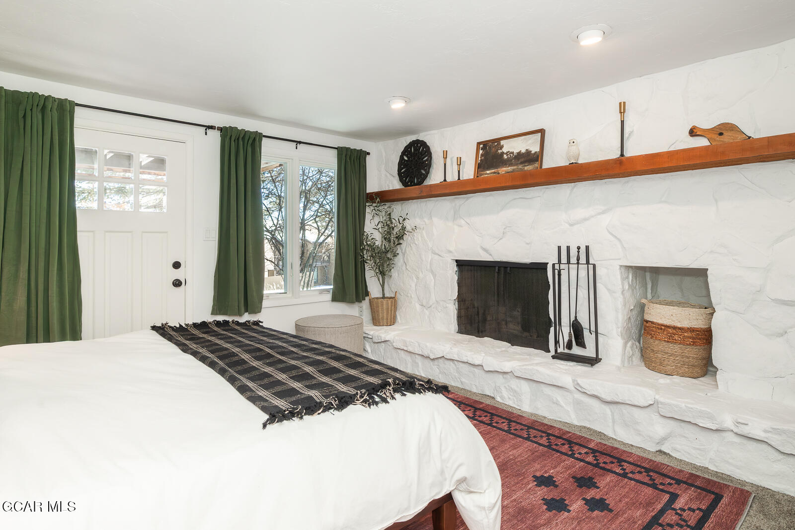 382 County Road 837 Fraser, CO 80442 - Photo 23 of 46 a bedroom with a large bed and a fireplace