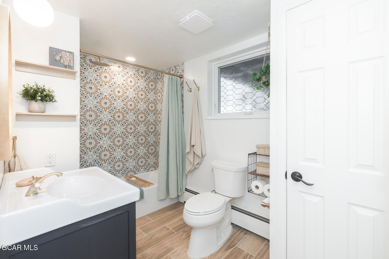 382 County Road 837 Fraser, CO 80442 - Photo 31 of 46 a bathroom with a sink a toilet and shower curtain