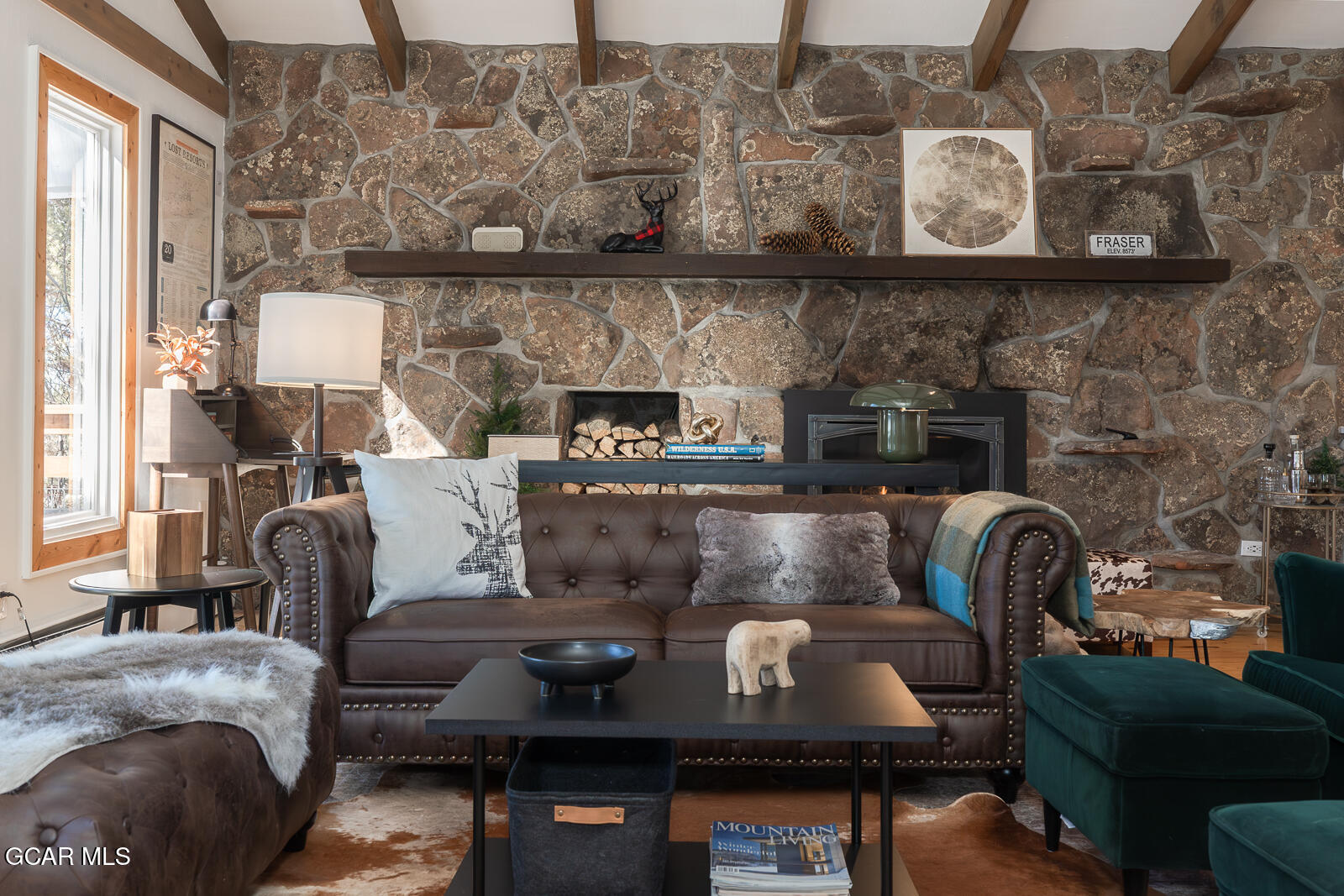 382 County Road 837 Fraser, CO 80442 - Photo 9 of 46 a living room with furniture and a fireplace