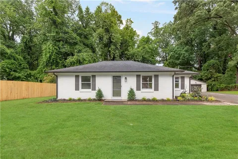 a front view of house with a garden