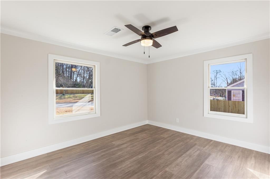 2260 Old Spring Road Smyrna, GA 30080 - Photo 20 of 29 a view of an empty room with wooden floor and a window