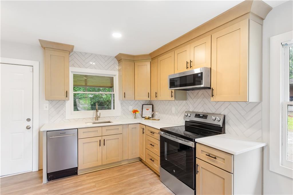 2260 Old Spring Road Smyrna, GA 30080 - Photo 3 of 29 a kitchen with a sink stove and microwave