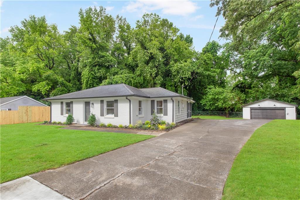 2260 Old Spring Road Smyrna, GA 30080 - Photo 6 of 29 a front view of a house with a garden