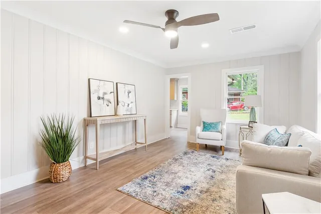 a living room with furniture and a potted plant