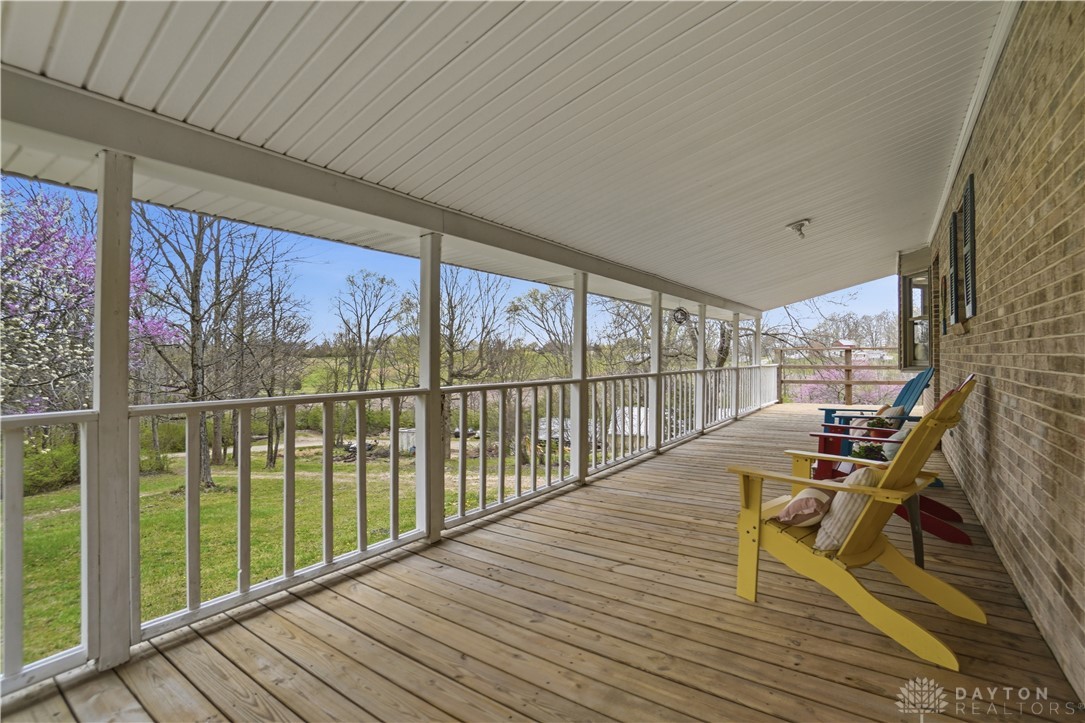 7553 Coffin Station Road Springfield, OH 45502 - Photo 87 of 95 Relax on the expansive deck overlooking a vibrant landscape.