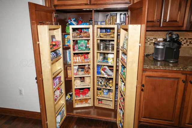 a kitchen with sink refrigerator and cabinets