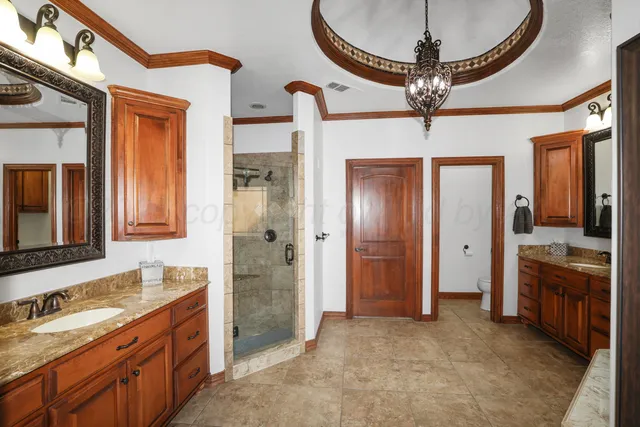 a bathroom with a sink a large mirror and a shower