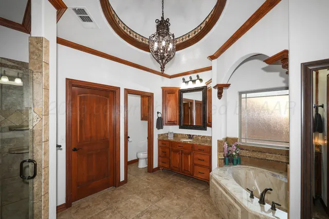 a bathroom with a tub a sink and a mirror
