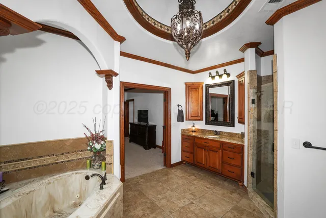 a bathroom with a tub a double vanity sink a mirror and a shower