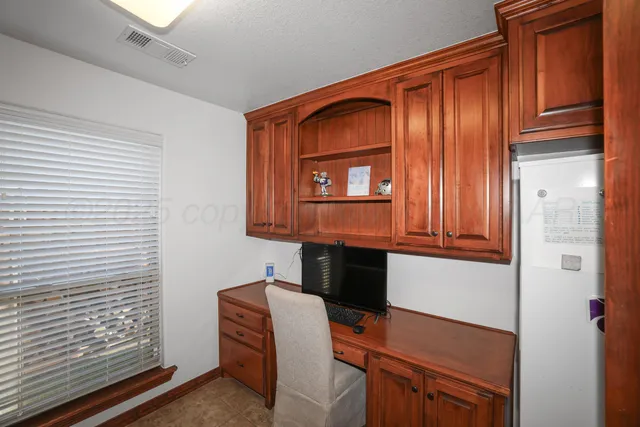 a kitchen with stainless steel appliances granite countertop a refrigerator and a cabinets