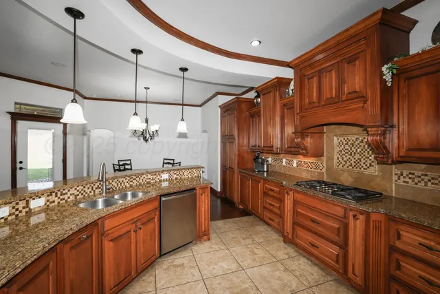 a kitchen with stainless steel appliances granite countertop a sink and cabinets