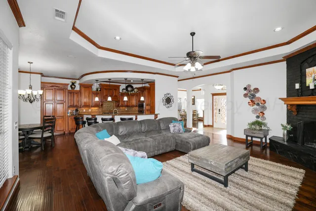 a living room with furniture and a chandelier