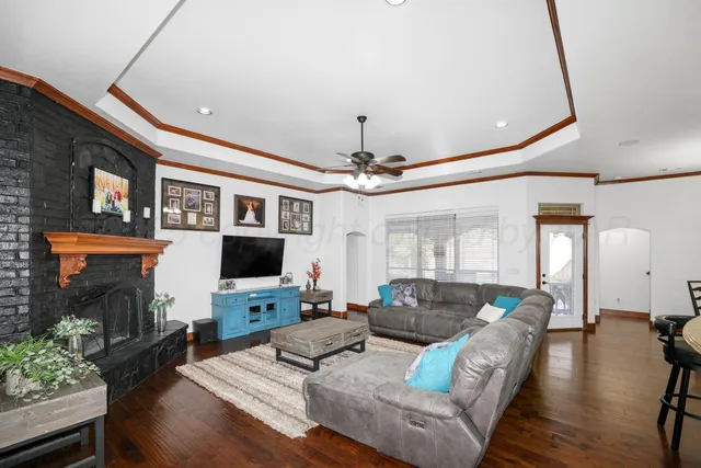 a living room with furniture a fireplace and a flat screen tv