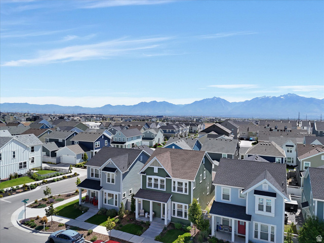 11759 South Watercourse Road South Jordan, UT 84009 - Photo 29 of 33 Residential street featuring a collection of two-story homes with varied exterior colors, front porches, and street-level landscaping