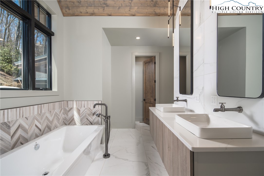 371 Ninebark Road Boone, NC 28607 - Photo 17 of 41 a bathroom with a bathtub and a sink