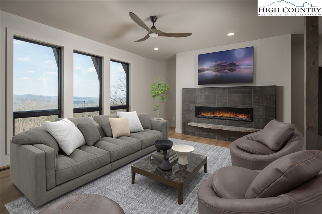 371 Ninebark Road Boone, NC 28607 - Photo 25 of 41 a living room with furniture ceiling fan and a fireplace