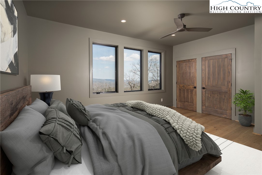 371 Ninebark Road Boone, NC 28607 - Photo 27 of 41 a bedroom with a bed and a lamp