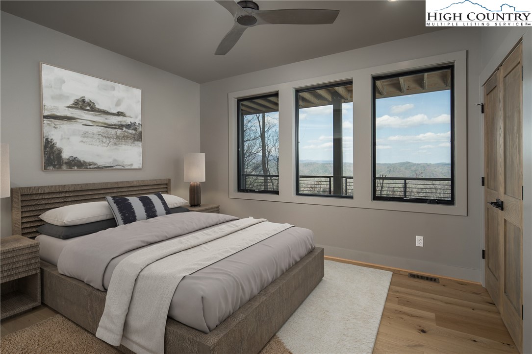 371 Ninebark Road Boone, NC 28607 - Photo 29 of 41 a bedroom with a large bed and a large window