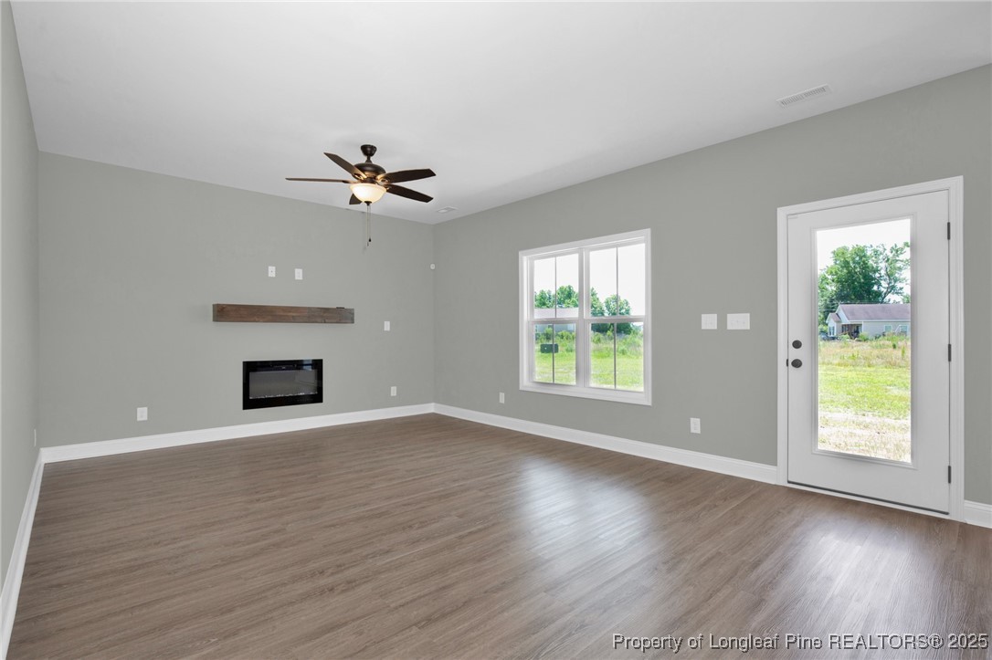 121 Merle Road Pinebluff, NC 28373 - Photo 10 of 28 an empty room with windows and a fireplace