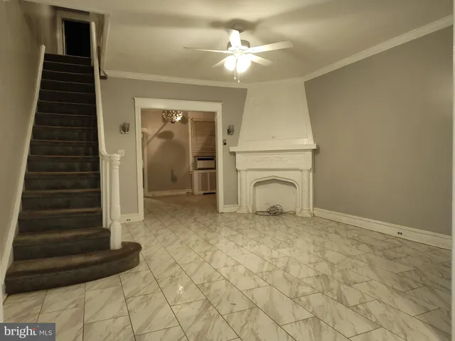 a view of a livingroom with furniture and chandelier fan