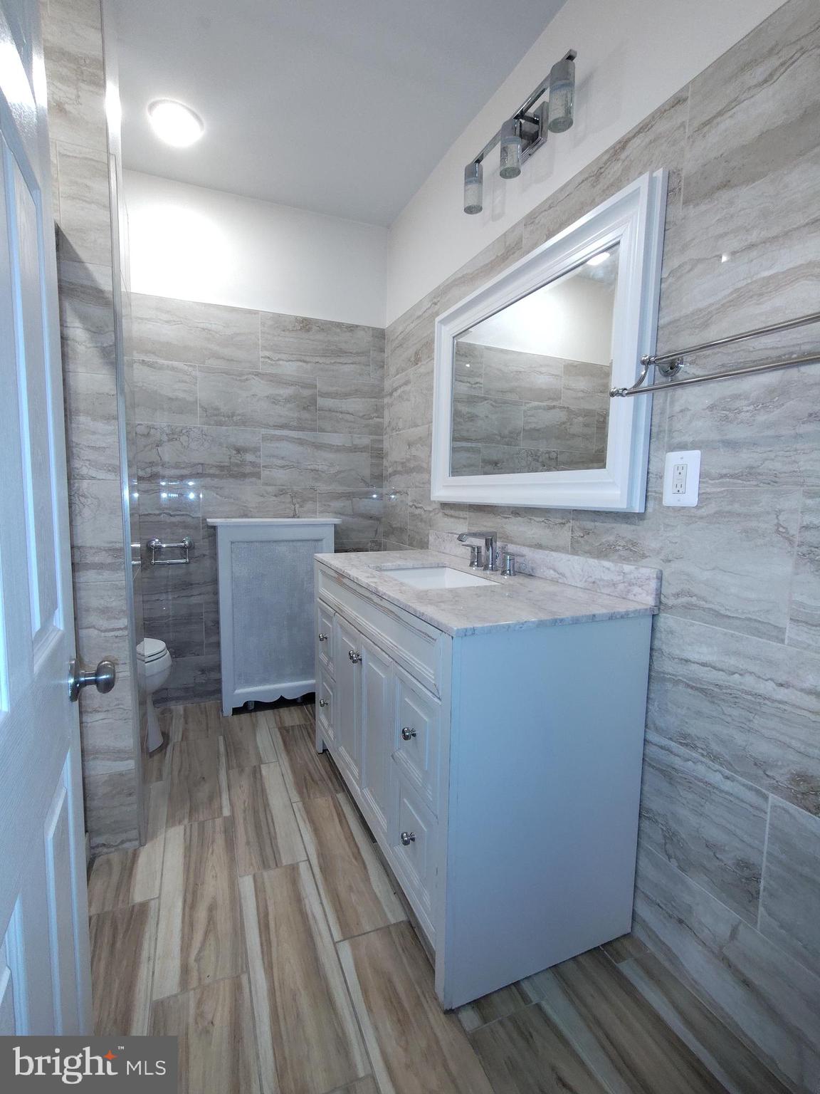 232 Copley Road Upper Darby, PA 19082 - Photo 11 of 21 a bathroom with a sink a toilet and mirror