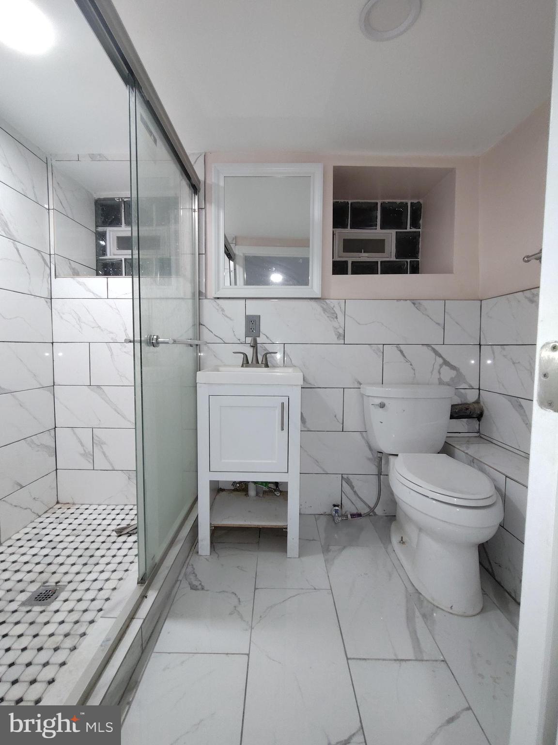 232 Copley Road Upper Darby, PA 19082 - Photo 20 of 21 a bathroom with a toilet sink and shower