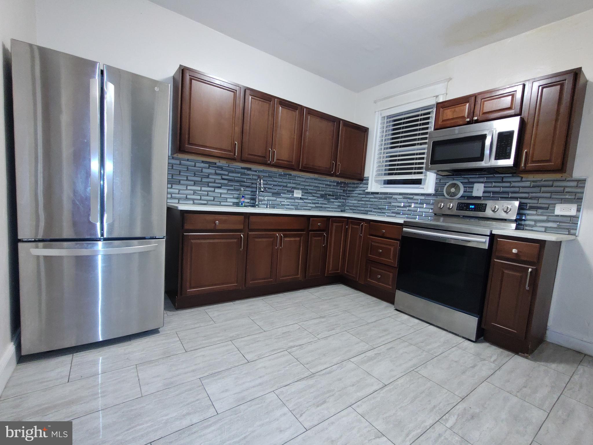232 Copley Road Upper Darby, PA 19082 - Photo 6 of 21 a kitchen with stainless steel appliances granite countertop a refrigerator and a sink