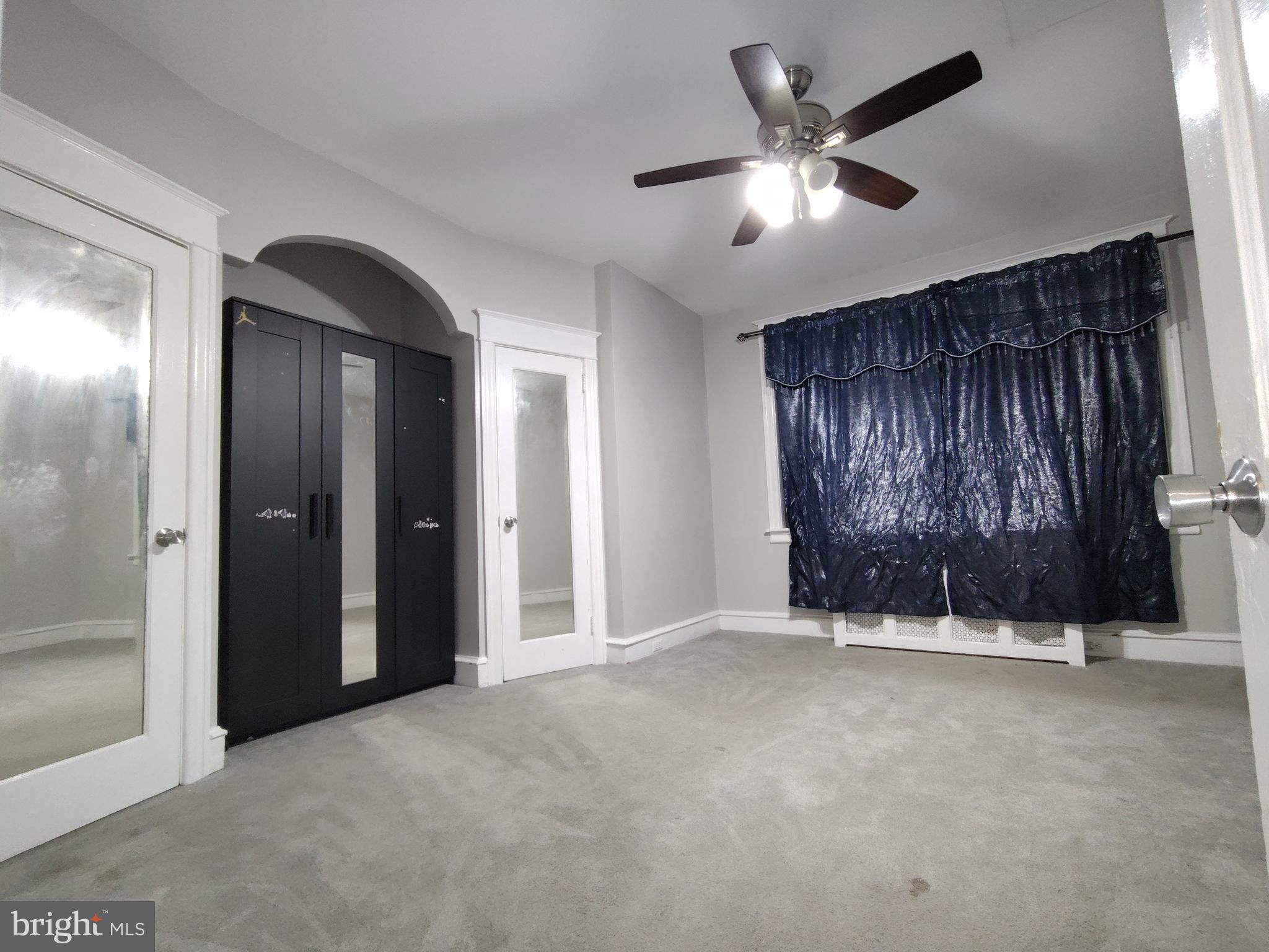 232 Copley Road Upper Darby, PA 19082 - Photo 9 of 21 an empty room with ceiling fan and window