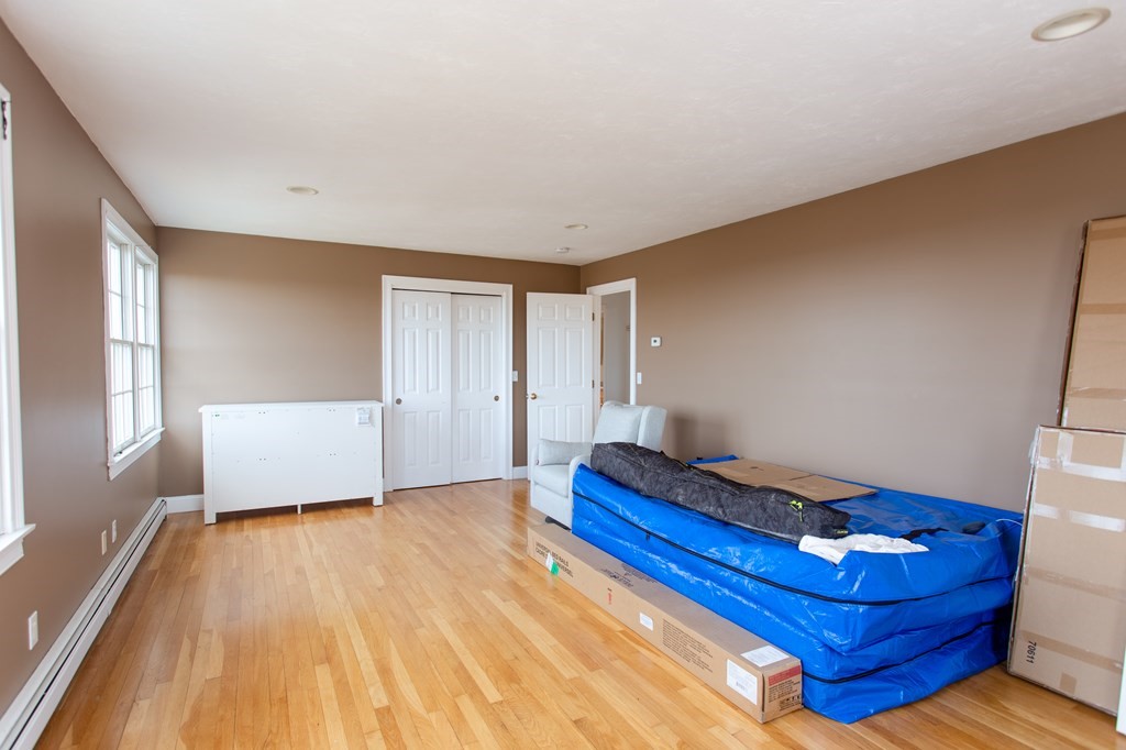 2 Desmond Road Bourne, MA 02561 - Photo 19 of 26 a bedroom with a bed and wooden floor